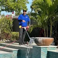 Complete Carpet Care technician pressure cleaning outdoors in Plant City FL