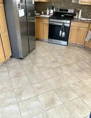 Kitchen tile floor with light grout lines after professional tile and grout cleaning, Complete Carpet Care in Plant City, FL