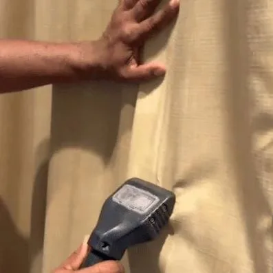 Technician steam cleaning curtains in Plant City FL